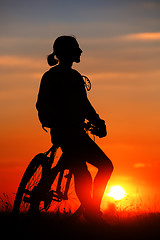 Image showing Silhouette of a bike on sky background