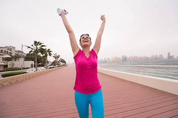 Image showing young woman celebrating a successful training run