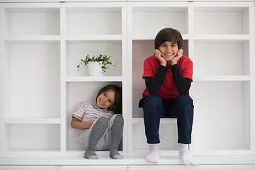 Image showing young boys posing on a shelf