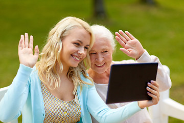 Image showing daughter with tablet pc and senior mother at park