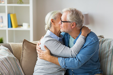 Image showing happy senior couple hugging at home