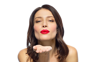 Image showing beautiful woman with red lipstick blowing air kiss