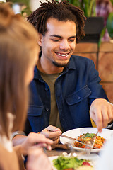 Image showing happy couple eating at restaurant