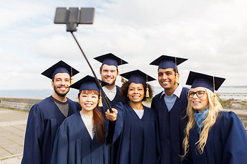 Image showing group of happy students or graduates taking selfie