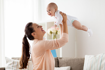 Image showing happy mother playing with little baby boy at home