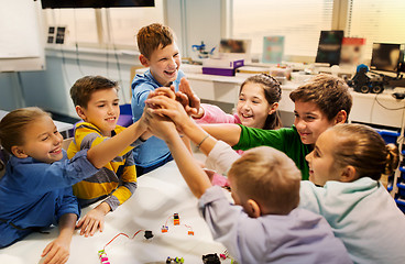 Image showing happy children making high five at robotics school