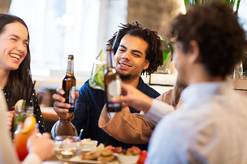 Image showing happy friends drinking non alcoholic beer at bar