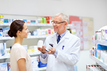 Image showing apothecary and woman with drug at pharmacy