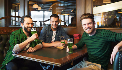 Image showing male friends drinking green beer at bar or pub