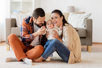 Image showing happy family with baby having fun at home