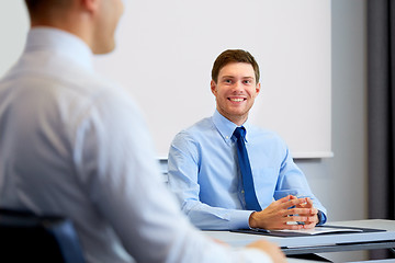 Image showing happy coworkers meeting and talking at office