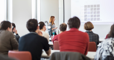 Image showing Woman giving presentation in lecture hall at university.