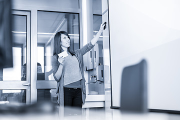 Image showing Woman giving presentation in lecture hall at university.