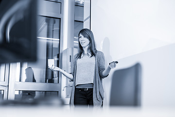 Image showing Woman giving presentation in lecture hall at university.