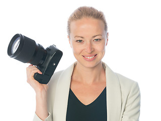 Image showing Woman photographer takes images with dslr camera