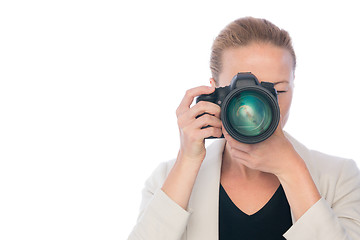 Image showing Woman photographer takes images with dslr camera