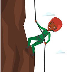 Image showing Woman climbing in mountains with rope.