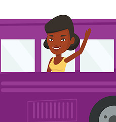 Image showing Woman waving hand from bus window.