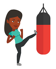 Image showing Woman exercising with punching bag.