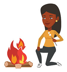 Image showing Woman roasting marshmallow over campfire.