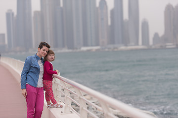 Image showing mother and cute little girl on the promenade