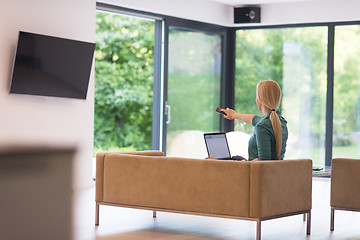 Image showing Young woman using laptop at home