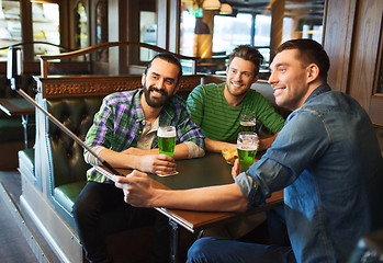 Image showing friends taking selfie with green beer at pub