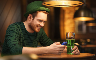 Image showing man with smartphone and green beer at bar or pub