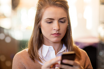 Image showing close up of young woman with smartphone