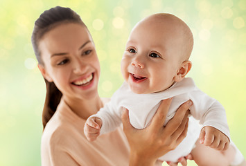 Image showing happy mother with little baby boy over green