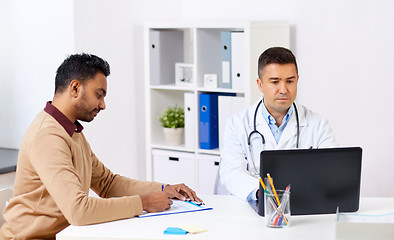 Image showing doctor with laptop and male patient at hospital