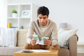 Image showing man counting money at home