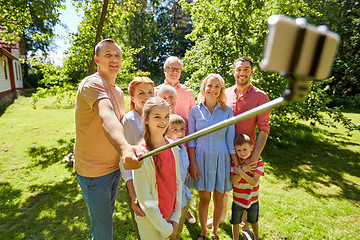 Image showing happy family taking selfie in summer garden