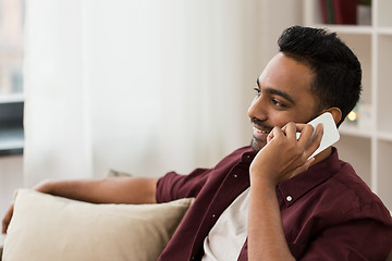 Image showing happy man calling on smartphone at home