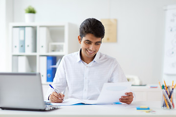 Image showing businessman working with papers at office