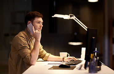 Image showing man calling on smartphone late at night office