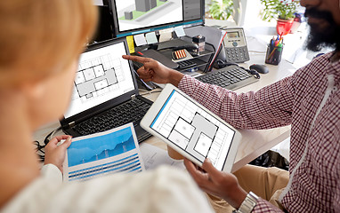 Image showing architectors with blueprints on computers