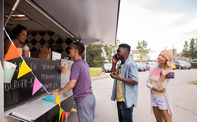 Image showing happy customers queue at food truck