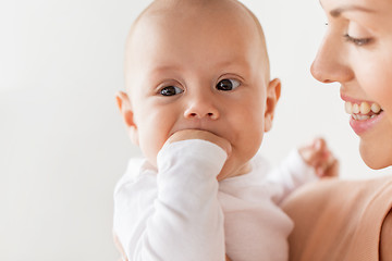 Image showing happy mother with little baby boy sucking fingers