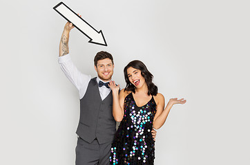 Image showing happy couple with big arrow at party