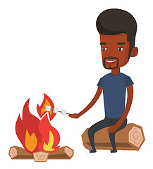 Image showing Man roasting marshmallow over campfire.