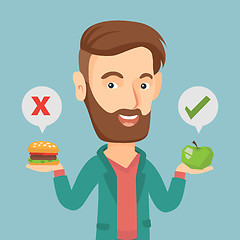 Image showing Man choosing between hamburger and cupcake.