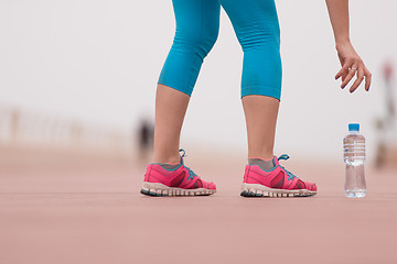 Image showing close up on running shoes and bottle of water