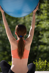 Image showing woman doing exercise with pilates ball