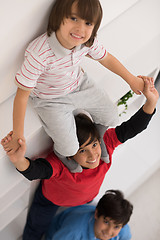 Image showing young boys posing line up piggyback top view