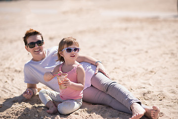 Image showing Mom and daughter on the beach