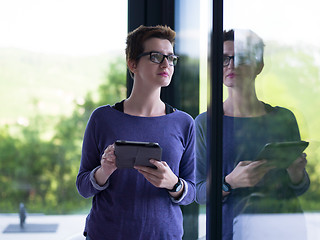 Image showing young women using tablet computer by the window