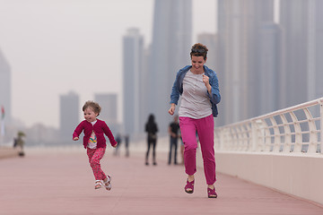 Image showing mother and cute little girl on the promenade