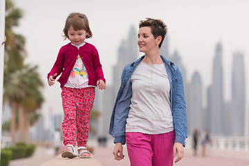 Image showing mother and cute little girl on the promenade