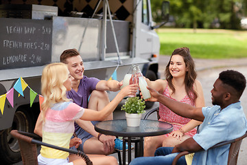 Image showing friends clinking bottles with drinks at food truck